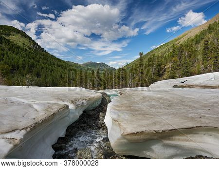 Mountain Landscape. Spring Melting Snow On A Mountain River.