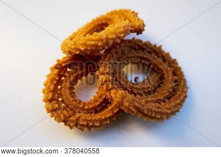 A Closeup View Of Traditional Homemade Muruku Snacks Isolated On White Background