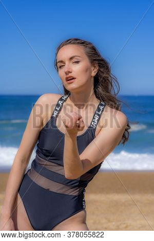 Hossegor, France 30.06.2020. Soft Focus. Beautiful Girl Posing On The Background Of A Wavy Ocean. Ou