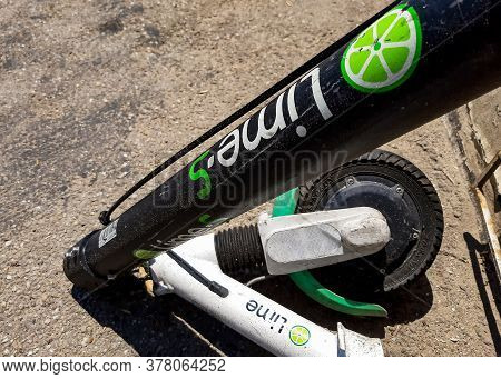 Bucharest, Romania - July 22, 2020: A Lime-s Electric Scooter Is Vandalized On A Sidewalk In Buchare