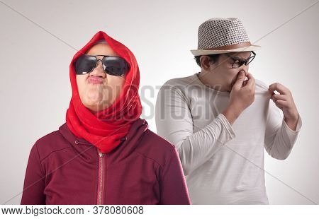 Funny Asian Man Embarrassed In Front Of Woman Fro Having Bad Body Odor Smell, Man Smelling His Own B