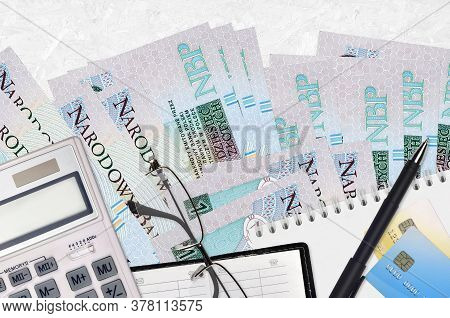10 Polish Zloty Bills And Calculator With Glasses And Pen. Tax Payment Concept Or Investment Solutio