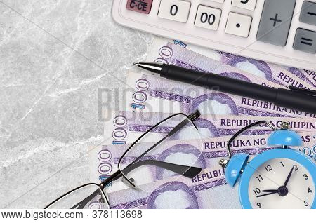 100 Philippine Piso Bills And Calculator With Glasses And Pen. Business Loan Or Tax Payment Season C
