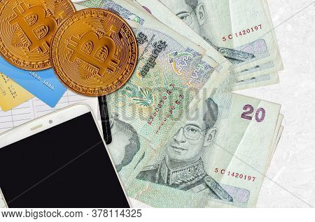 20 Thai Baht Bills And Golden Bitcoins With Smartphone And Credit Cards. Cryptocurrency Investment C
