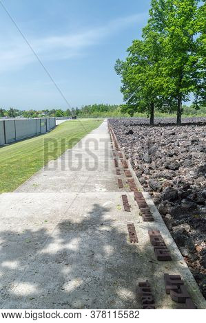 Belzec, Poland - June 12, 2020: Alley With City Names Inscription In Yiddish And Polish Language At 