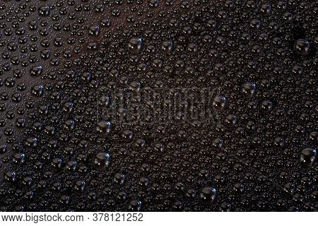 Many Small Water Drops On The Black Surface Of Cellphone Hydriphobic Coated Glass Screen
