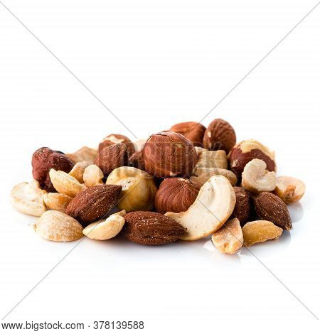 Pile Of Multiple Nuts, Mix Of Salted Hazelnuts, Almonds, Cashews And Peanuts Isolated On A White Bac