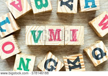 Alphabet Letter Block In Word Vmi (abbreviation Of Vendor Managed Inventory) With Another On Wood Ba