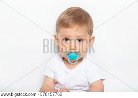 Caucasian Little Child Boy And Plastic Baby Soother Pacifier