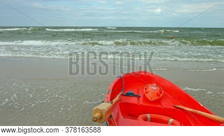 Red baywatch boat on beach. Rescue boat for emergency alert. Slowmotion.