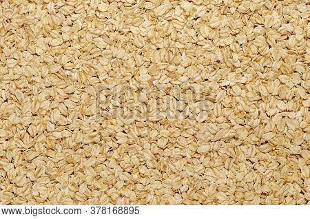 Rolled Oats, Surface And Background. Lightly Processed Whole-grain Food. Husked And Steamed Oat Groa