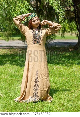 Armenian Young Woman In Traditional Clothes In The Forest