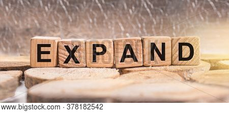 Wooden Blocks With The Word Expand. Business And Finance Concept.