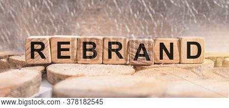 Wooden Blocks With The Word Rebrand. Business And Finance Concept.