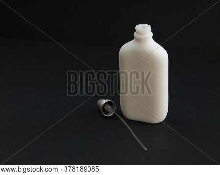 Open White Non-transparent Bottle With Perfume Next To The Dispenser On A Black Background