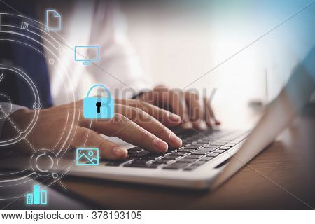 Information Security. Young Man Using Laptop At Table Indoors, Closeup