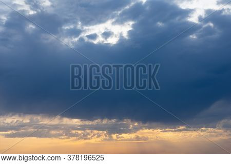 Dramatic Rainy Clouds On Orange And Dark Blue Evening Sky. Natural Background With Stormclouds And S