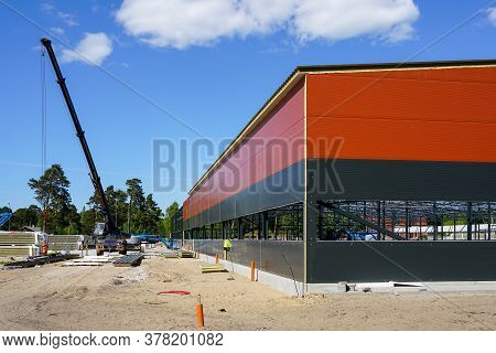 Truck Mounted Crane With A Telescoping Boom At Constructing A Metal Carcas Of A New Building