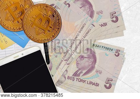 5 Turkish Lira Bills And Golden Bitcoins With Smartphone And Credit Cards. Cryptocurrency Investment