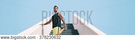 Stretch warm-up leg exercise fit man getting ready to run up the stairs for uphill hiit interval cardio training at outdoor gym. Runner athlete running.