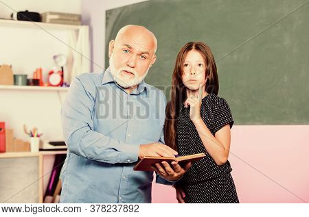Teacher Help Schoolgirl. Back To School. School Lesson. Little Girl With Man Tutor Study. Experience