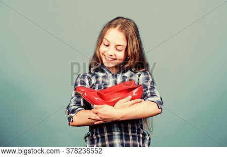 Shoe Care. Happy Childhood. Small Girl With Stylish Shoes. Happy Child Hold Fashionable Shoe. High H