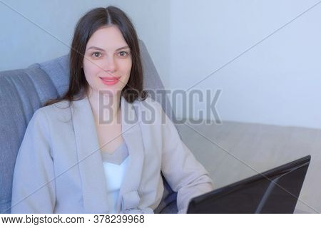 Freelancer Woman Working On Laptop At Home Sitting On Couch Looking At Camera, Freelance Distant Wor