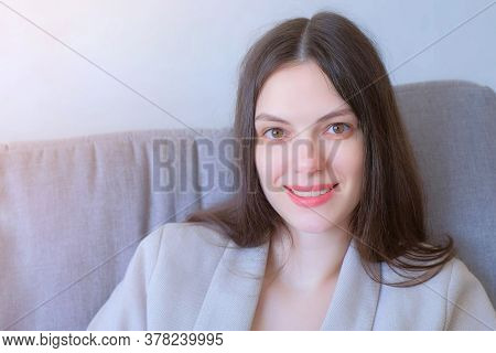 Portrait Of Woman Looking At Camera And Smiling At Home Sitting On Couch, Freelance Distant Work On 