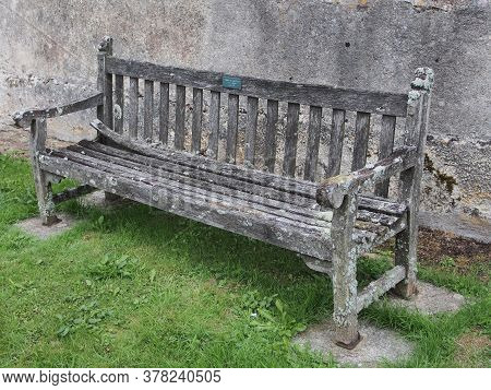 A Wooden Chair Outside In The Park