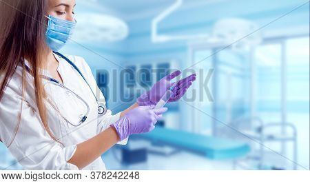 Asisstant Doctor In Operating Room. Light Background.