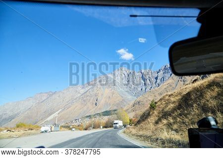 Tbilisi, Georgia - October 25, 2019: Car Vindow, Hand Of Woman On Steering Wheel And View To The Roa