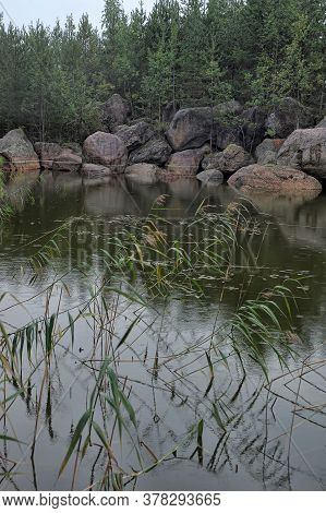 A Small Forest Lake And Large Stones