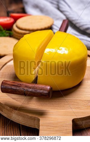 Dutch Baby Gouda Cheese In Yellow Wax Close Up