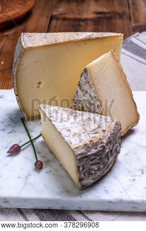 Pieces Of Cheese Tomme De Montagne Or Tomme De Savoie Made From Cow Milk In French Alps.