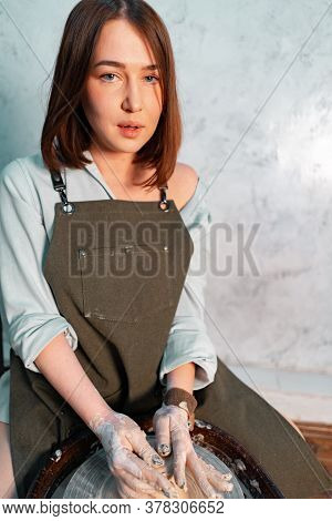 Portrait Of Attractive Sexy Woman Sculptor Artist In Modern Workshop Studio Making Crockery Or Sculp