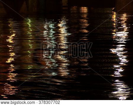Reflection In The Water Of Night Lights