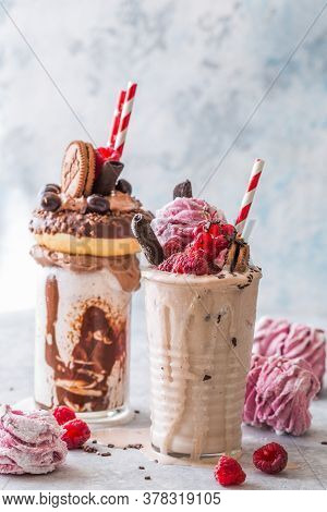 Chocolate Indulgent Frosting Exreme Milkshake With Donut  And Sweets. Crazy Freakshake Food Trend. C