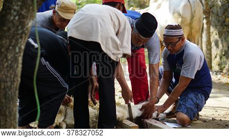 Yogyakarta, Indonesia - August 11th 2019: Eid Al-adha Celebration. Muslim People Help Each Other In 