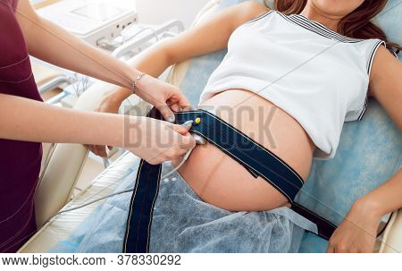 Pregnant Woman With Electrocardiograph Check Up For Her Baby