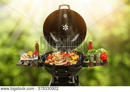 Barbecue Grill With Meat Products And Vegetables Outdoors On Sunny Day