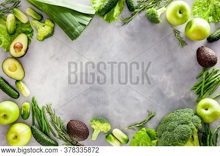 Green Vegetables Background. Сucumber, Avocado, Broccoli, Beans, Leek And Fresh Apple On Grey Stone 