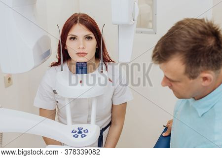 A Girl Patient Makes A Panoramic X-ray Of The Oral Cavity On An Orthopantomographic Apparatus, And T