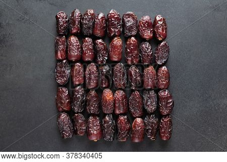 Dry Medjool Dates On Black Slate Background. Group Of Dried Date Fruits. Arabic Food