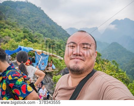 Portrait Photo Of Fun Tourist On The Peak Of Pha Ngeun In Vangvieng City Laos.vangvieng City The Fam