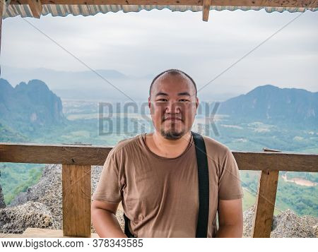 Portrait Photo Of Fat Tourist With Beautiful View On The Peak Of Pha Ngeun In Vangvieng City Laos.va