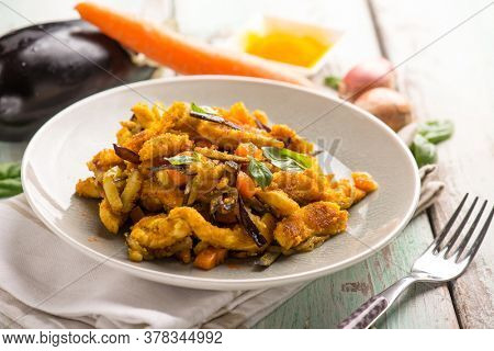 chicken stewed with eggpalnts carrots basil and turmeric spice