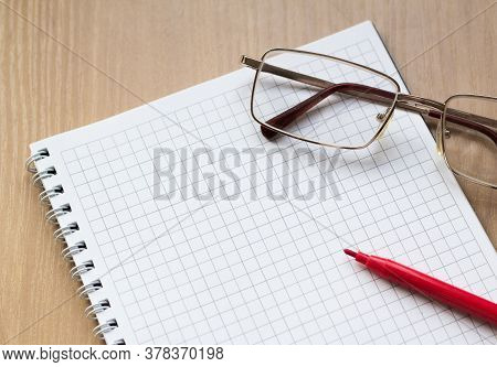 Opened Ruled Note Book With Pen And Spectacle. Selective Focus Of Notebooks, Pens, Glasses Backgroun
