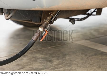 Auto Refuel. Car At Gas Station Being Filled With Fuel. The Car Is Filling Lpg With Nozzles, Liquid 