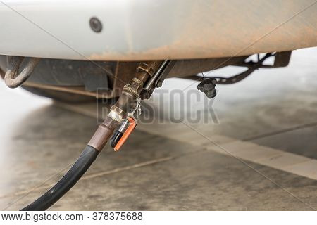 Auto Refuel. Car At Gas Station Being Filled With Fuel. The Car Is Filling Lpg With Nozzles, Liquid 