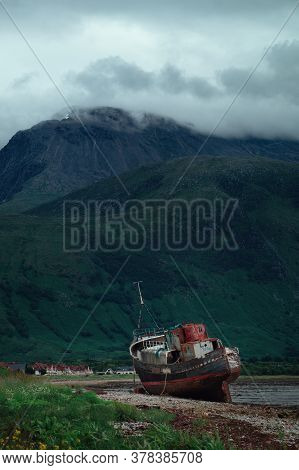 An Old Ship Washed Ashore On Loch Linnhe At Fort William On The Highland Coast Of Scotland. Opposite